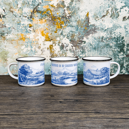 Three enamel camping cups feature a blue and white toile de Jouy design depicting scenes from Stardew Valley.