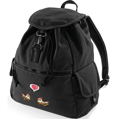 A black canvas backpack features embroidered pixel art of chickens flanking a heart emote referencing the Stardew Valley video game.