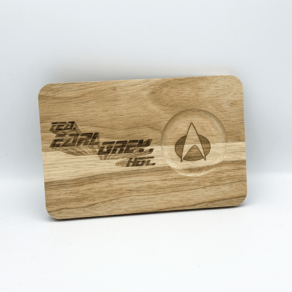 A wooden chopping board features laser-engraved text reading "Tea, Earl Grey, Hot" and a Star Trek delta shield symbol.