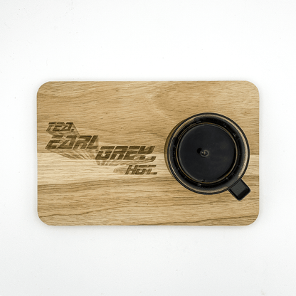 A wooden chopping board features laser-engraved text reading "Tea, Earl Grey, Hot," referencing Star Trek: The Next Generation.