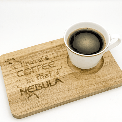 A white mug filled with coffee sits on a Voyager Breakfast Board featuring laser-engraved text reading "There's Coffee in that Nebula.