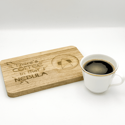 A wooden Voyager Breakfast Board features engraved text reading "There's Coffee in that Nebula" and a Star Trek delta shield logo next to a cup of coffee.