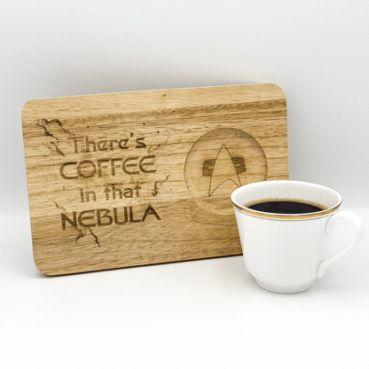 A wooden Voyager chopping board displays the phrase "There's Coffee in that Nebula" alongside a Star Trek delta shield logo next to a cup of coffee.