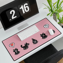 An extra large desk mat featuring a black and white pixelated cat pattern inspired by Stardew Valley is displayed on a desk next to a computer and clock.