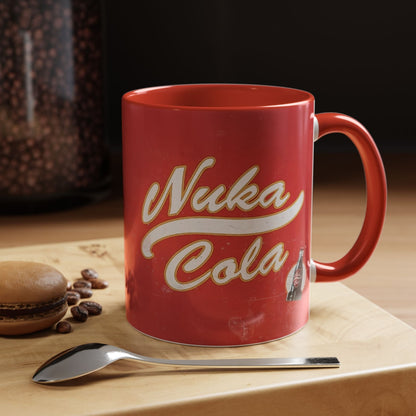 A red mug features a distressed vintage poster design with "Nuka Cola" lettering and a small illustration referencing the Fallout video game series.