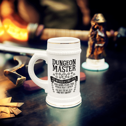 A white ceramic Dungeon Master tankard, resembling a DnD beer stein, sits on a wooden surface surrounded by fantasy-themed decorations.
