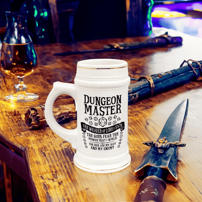 A white ceramic Dungeon Master tankard, resembling a D&D beer stein, sits on a wooden surface alongside dice and other fantasy-themed props.