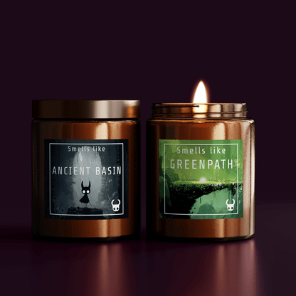 Two copper-colored jars of Hollow Knight-inspired scented candles feature labels depicting scenes from the game and listing fragrance names like Ancient Basin and Greenpath.