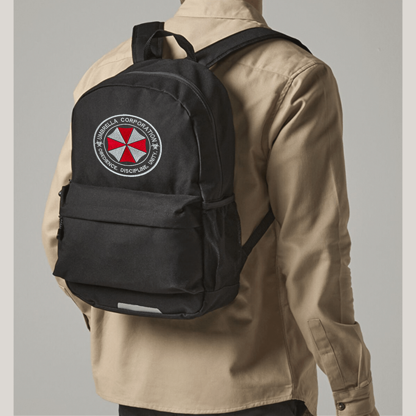 Person wearing a black backpack with Umbrella corporation logo on a gray background