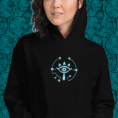 A person wears a black Zelda Sheikah Eye embroidery hoodie featuring a glow-in-the-dark design inspired by The Legend of Zelda: Tears of the Kingdom and Breath of the Wild.