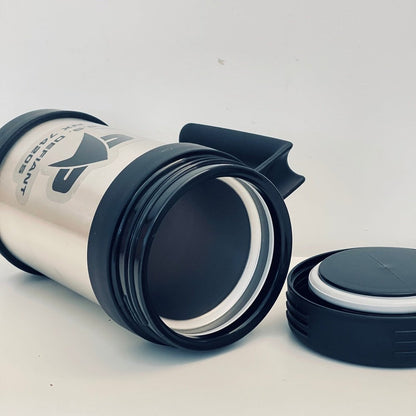 A black travel mug inspired by the USS Defiant from Star Trek features a white section displaying the ship's designation "NX-74205".