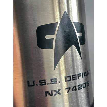 The silver travel mug displays the Star Trek insignia and "U.S.S. DEFIANT NX 74205" in black lettering.