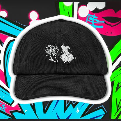 A black cotton corduroy baseball cap features embroidered white designs of a betta fish and stylized feathers against a colorful background referencing Jujutsu Kaisen.