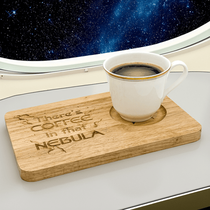 A Voyager Breakfast Board displays the engraved phrase "There's Coffee in that Nebula" while holding a full cup of coffee against a backdrop of stars and a spaceship window.