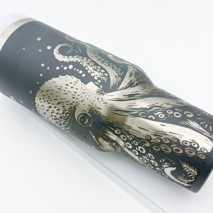 A gray 40oz tumbler features an engraved design of a Kraken octopus with detailed tentacles and bubbles.