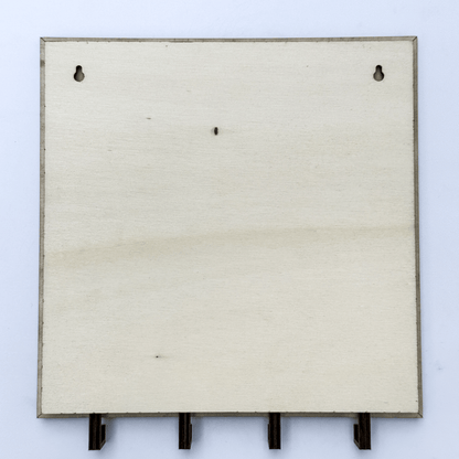 This wooden key holder features a laser-cut carpet pattern reminiscent of The Shining and includes four hooks for keys.