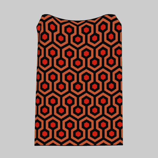 Patterned fabric with red and black hexagonal design on a green background