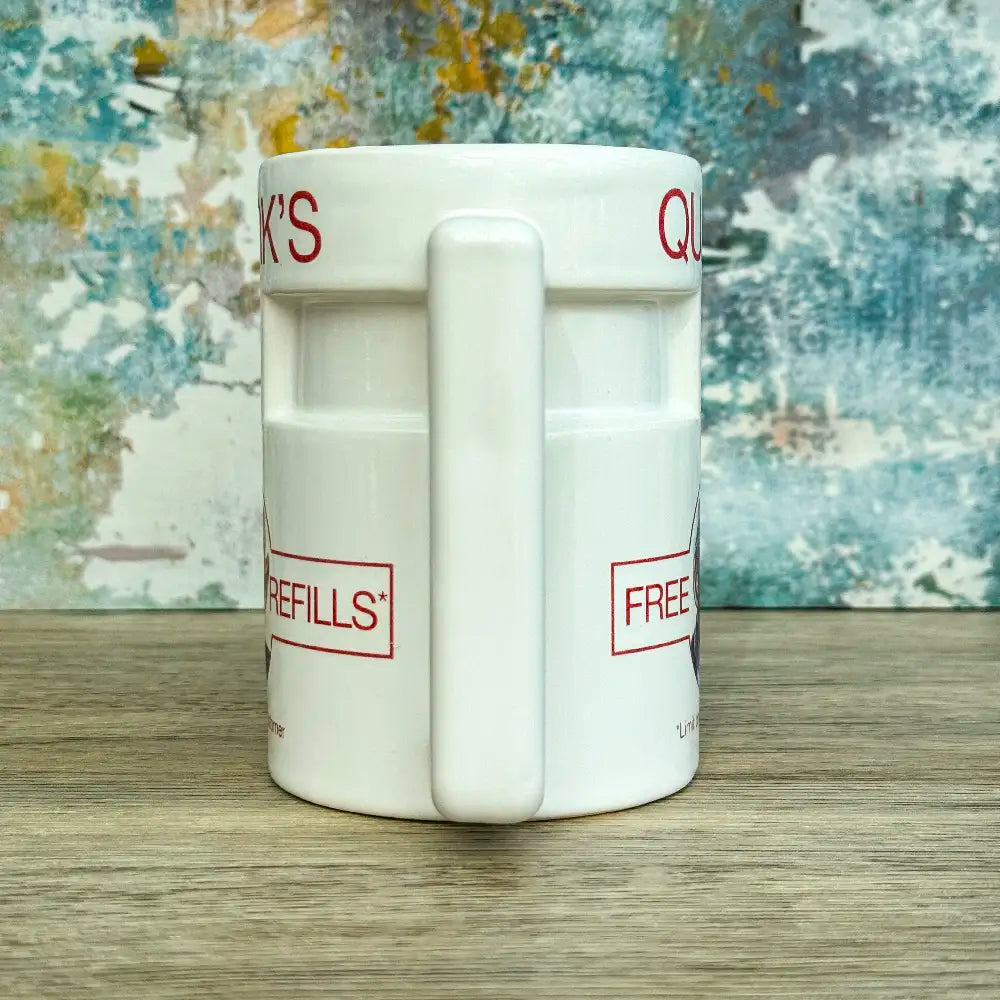 Quarks Bar Mug replica from Star Trek Deep Space Nine labelled "Quark's" with a portrait of Quark and text promoting free refills, against a colourful background