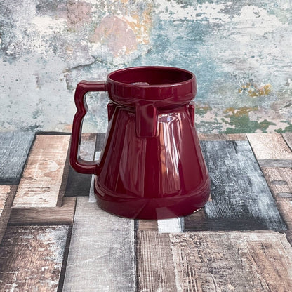 This is a red Raktajino replica mug styled to resemble a Big Red Synth Ale container from Quark’s Bar on DS9.