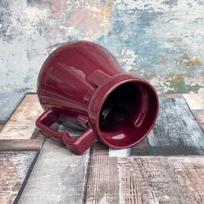 This is a close-up of a deep red Raktajino replica mug resembling a Big Red Synth Ale container from Quark’s Bar in DS9.