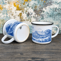 A blue and white Stardew Valley Chinoiserie camping cup features a detailed toile de Jouy design depicting a landscape scene.