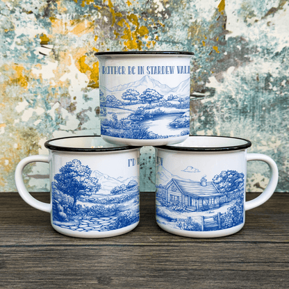 Three enamel camping cups feature a blue and white toile de Jouy design inspired by the computer game Stardew Valley, depicting landscapes and including text referencing the game.