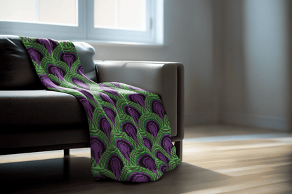 Room 237 Overlook Hotel - Green and purple patterned blanket draped over a gray sofa in a room with wooden flooring.