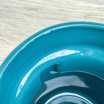 A handmade "Rejected Raktajino Mug" by Quirkify, sitting on a wooden surface. Give one a good home today!.