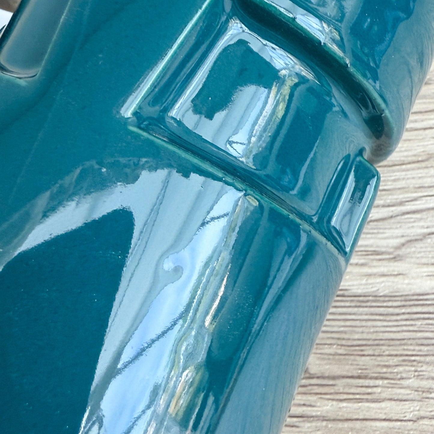 A handmade "Rejected Raktajino Mug" by Quirkify, sitting on a wooden surface. Give one a good home today!.