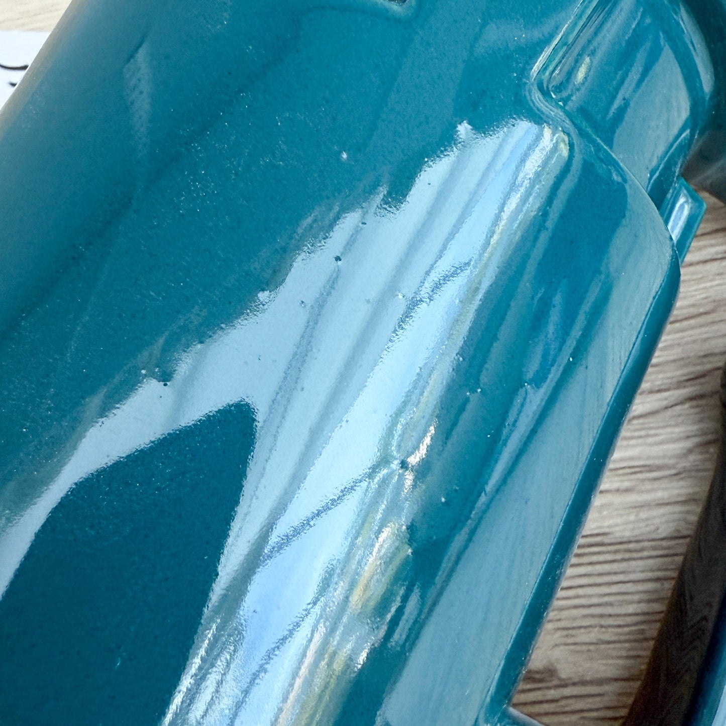 A handmade "Rejected Raktajino Mug" by Quirkify, sitting on a wooden surface. Give one a good home today!.