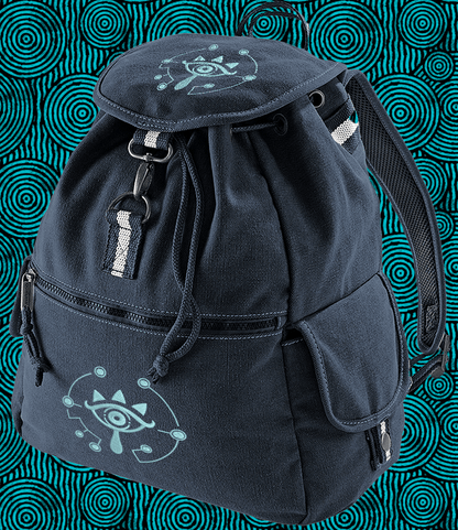 This dark blue Zelda Sheikah backpack features glow-in-the-dark embroidery of a stylized eye symbol on the front and top.