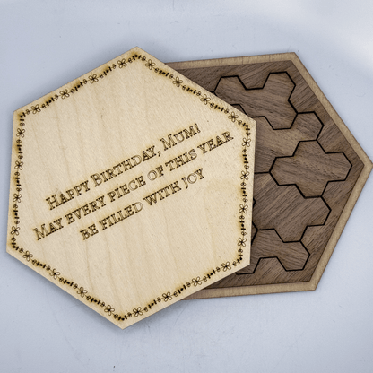 A wooden hexagon calendar puzzle features a central tile inscribed with "Happy Birthday, Mum! May every piece of this year be filled with joy.