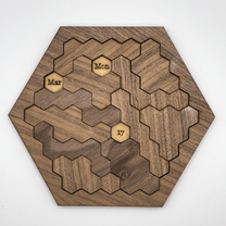 This wooden hexomino puzzle, inspired by Star Trek, displays the dates "Mar," "Mon," and "17" on rotating sections.