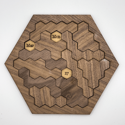 This wooden hexomino puzzle, inspired by Star Trek, displays the dates "Mar," "Mon," and "17" on rotating sections.