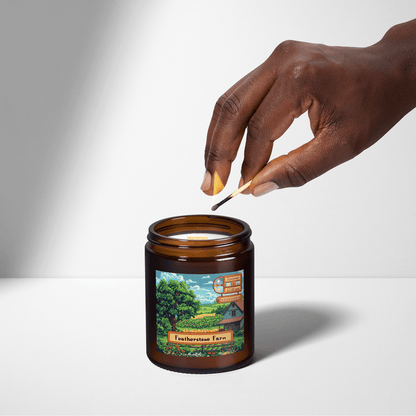 A hand extinguishes a Stardew Valley scented candle featuring an illustration of Featherstone Farm on its label.