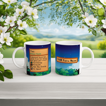 A white Stardew Custom Farm mug displays a graphic of tea artisan goods on one side and a mountain landscape with customizable farm name on the other.