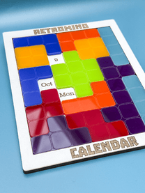 A KronoBlox puzzle calendar displays October 8th on a Monday, featuring colorful tetromino blocks arranged within a white frame labeled "Retromind Calendar.