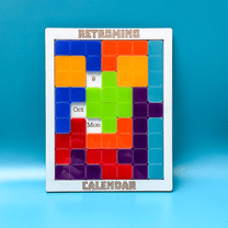 A colorful KronoBlox puzzle calendar displays the date as October 9th, Monday, featuring a Tetromino arrangement and the brand name Retromind.