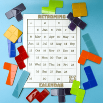 Colorful KronoBlox puzzle pieces are arranged around a calendar labeled "Retromind Calendar" displaying dates and months.