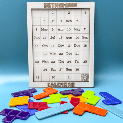 A RetroMind calendar displays dates alongside colorful Tetromino puzzle pieces arranged on a blue surface.