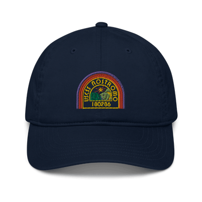 A navy blue baseball cap features an embroidered logo of the USCSS Nostromo with a rainbow style design and the number 180286.