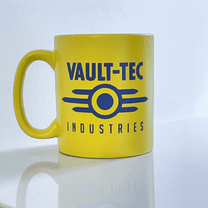 A yellow Fallout mug displays the Vault-Tec Industries logo in blue.