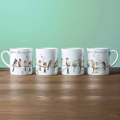 Four white china mugs display watercolour illustrations of birds perched on a branch, each featuring space for personalized text.