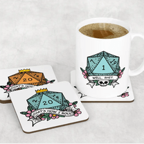 A white mug and two coasters display a D&D-themed design featuring a critical fail blue D20 die and the words "Well Shit / That's How I Roll.