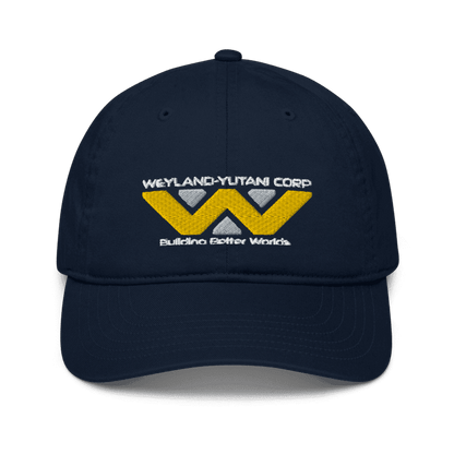 A navy blue baseball cap features an embroidered Weyland-Yutani Corp logo and the words "Building Better Worlds".