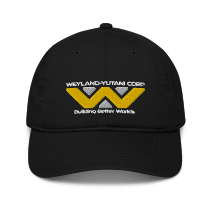 A black baseball cap features an embroidered Weyland-Yutani Corp logo with yellow lettering and a stylized "W" design above the words "Building Better Worlds.