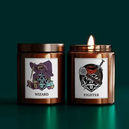 Two DnD scented candles are displayed side-by-side; one labeled "Wizard" features an illustration of a wizard's hat and dice, while the other labeled "Fighter" depicts a sword and shield design alongside a die.