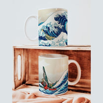 Two white mugs display a design combining Hokusai's Great Wave off Kanagawa with Link from The Legend of Zelda: Wind Waker sailing through the waves.