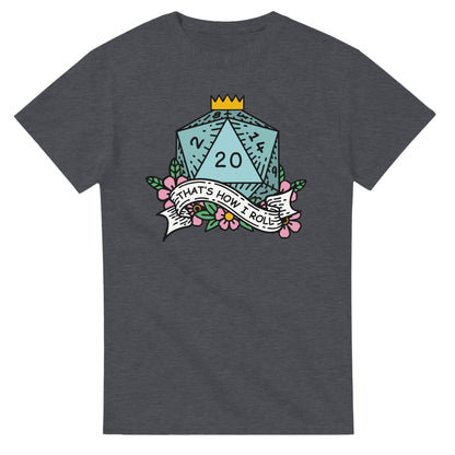 A dark gray t-shirt displays a D20 die surrounded by floral elements and a banner reading "That's How I Roll," referencing the D&D game.