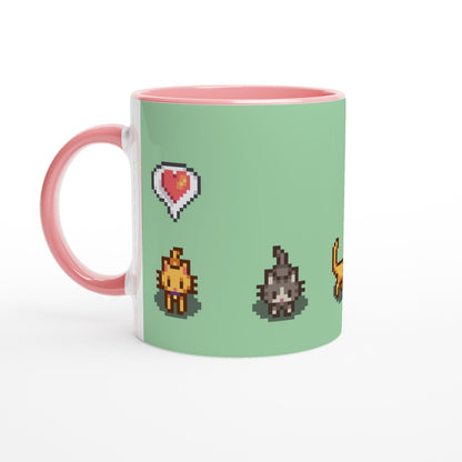 A white mug features pixelated graphics from Stardew Valley including a ginger tabby cat, heart emote, and lightning bolt.